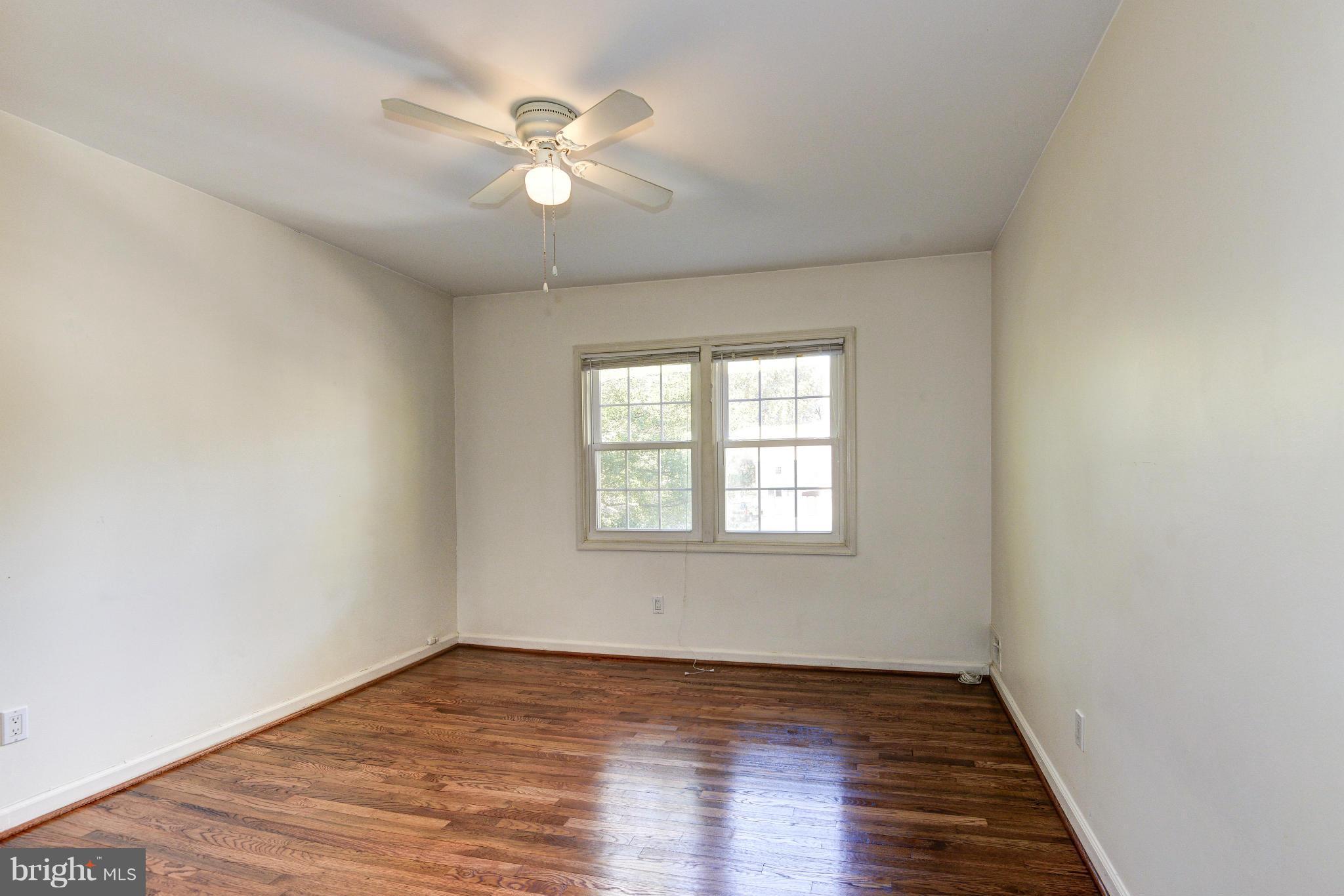 8306 Wickham Road Springfield, VA 22152 - Photo 17 of 29 an empty room with wooden floor and windows