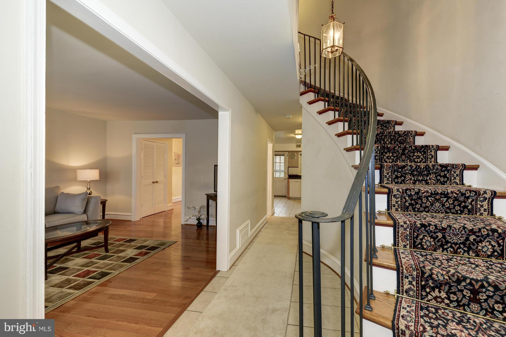 8306 Wickham Road Springfield, VA 22152 - Photo 3 of 29 a view of a hallway with wooden floor and staircase