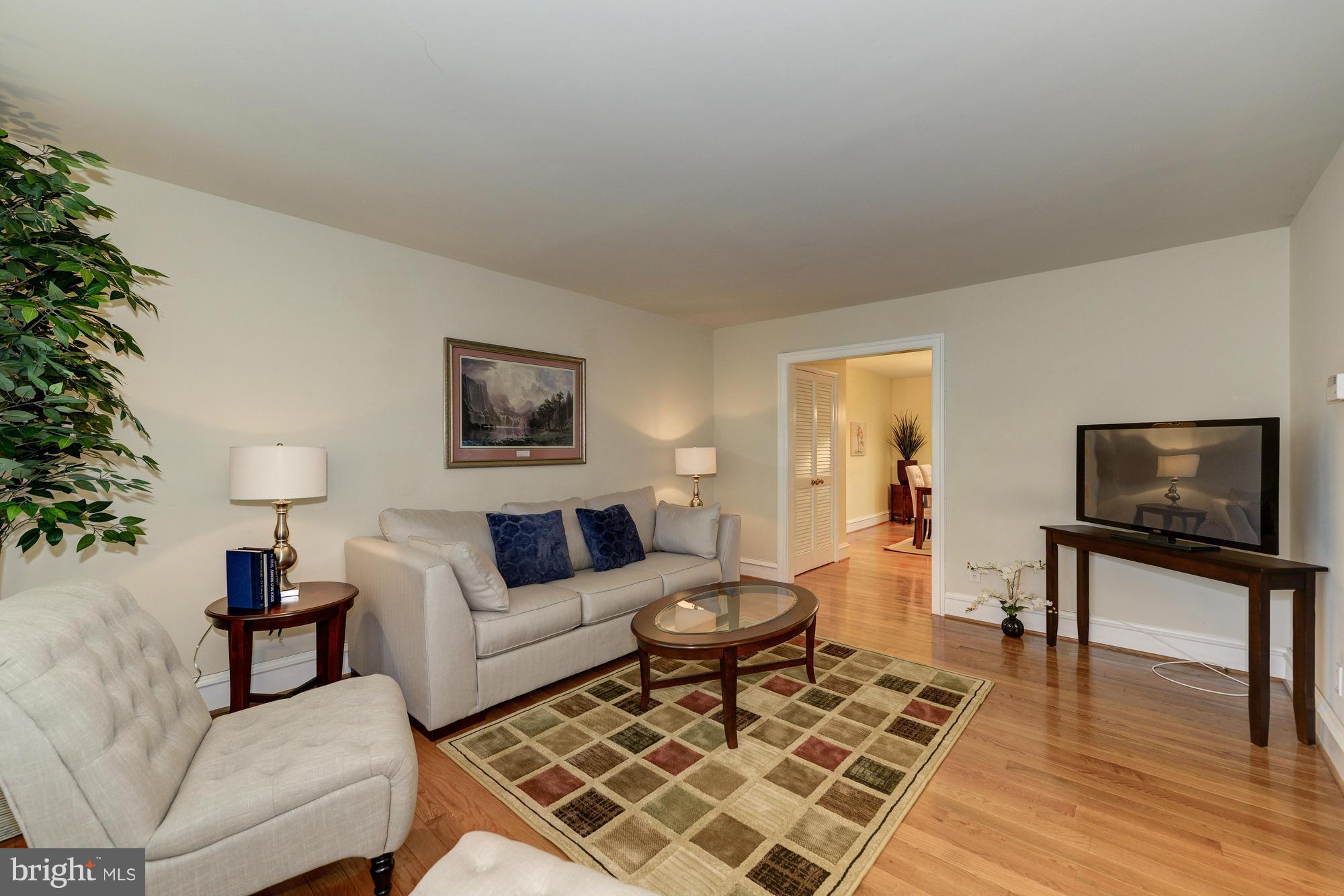 8306 Wickham Road Springfield, VA 22152 - Photo 4 of 29 a living room with furniture and a flat screen tv