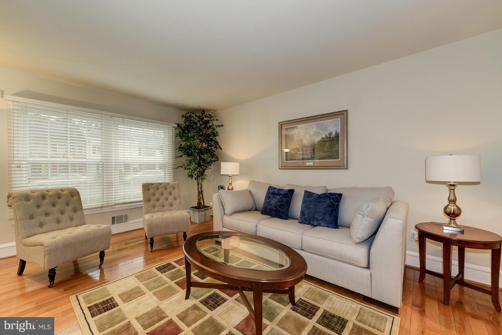 8306 Wickham Road Springfield, VA 22152 - Photo 5 of 29 a living room with furniture a lamp a rug and a window