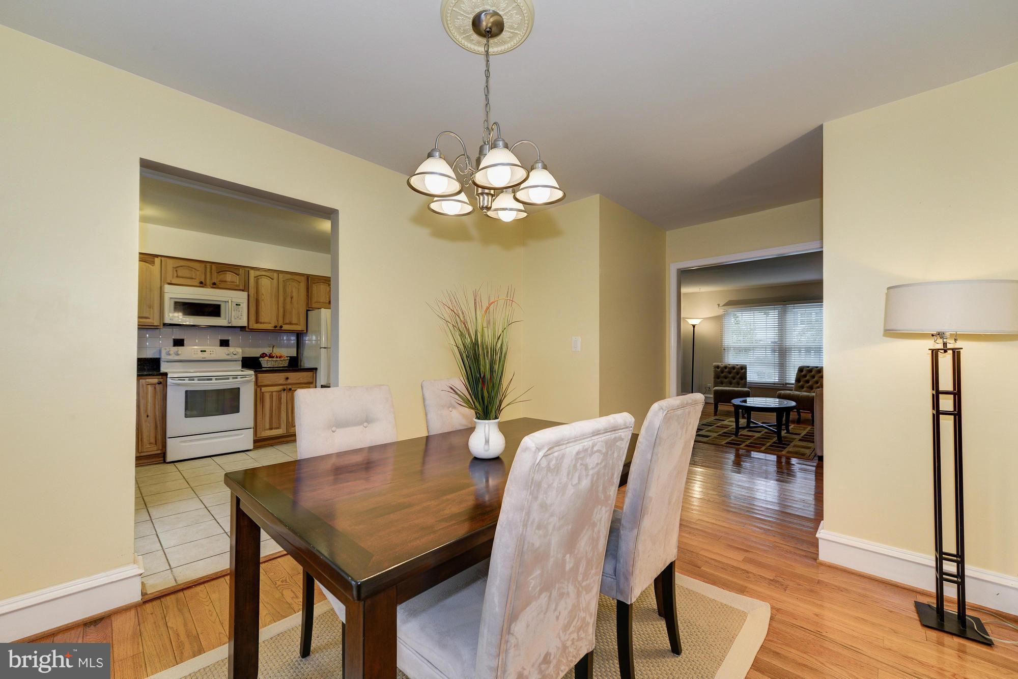 8306 Wickham Road Springfield, VA 22152 - Photo 7 of 29 a view of a dining room with furniture and wooden floor