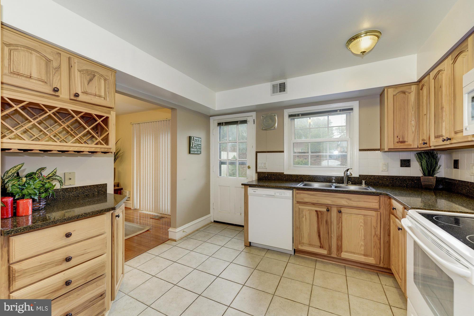 8306 Wickham Road Springfield, VA 22152 - Photo 8 of 29 a kitchen with granite countertop white cabinets and white appliances