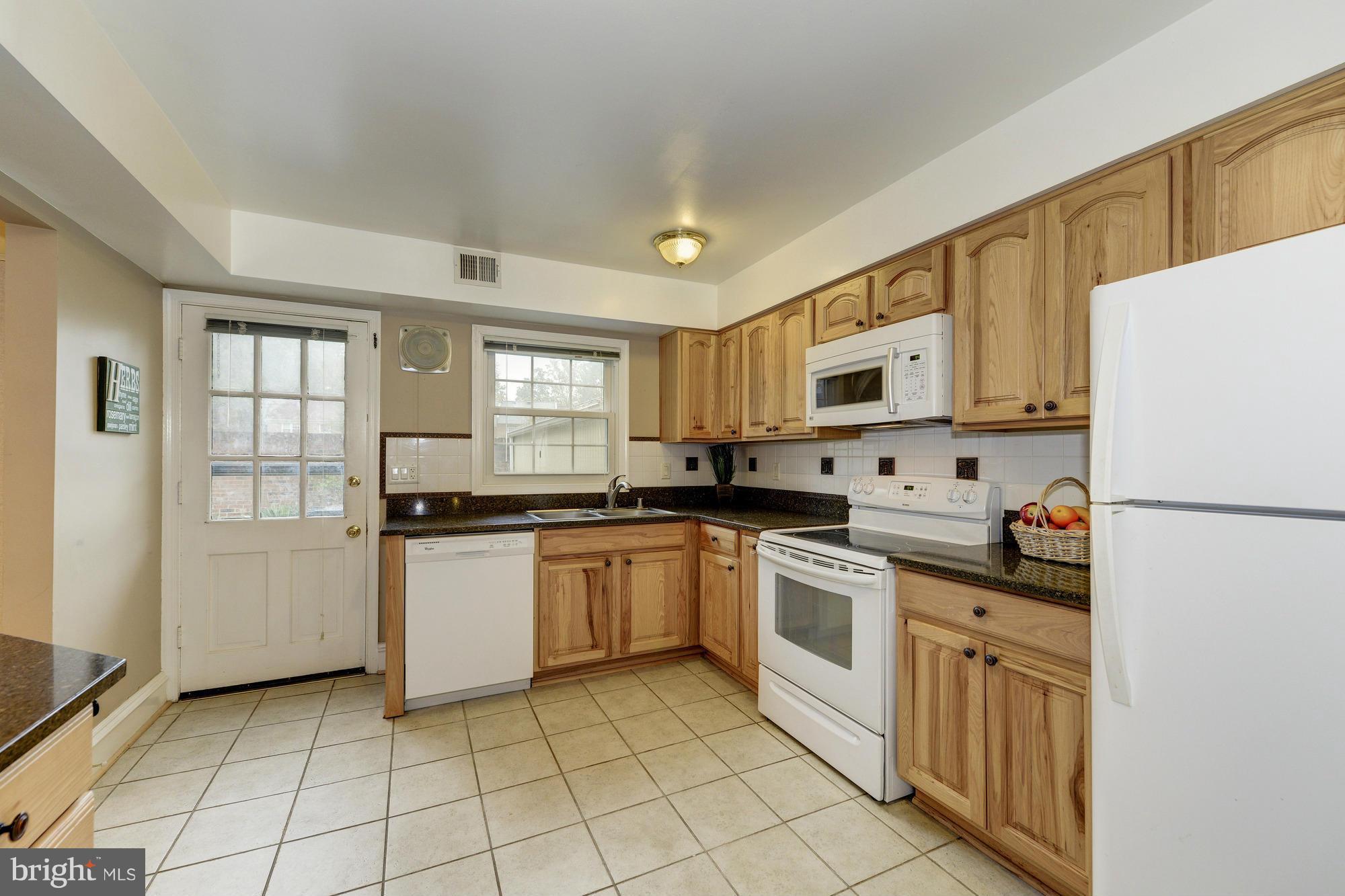 8306 Wickham Road Springfield, VA 22152 - Photo 9 of 29 a kitchen with white cabinets and white appliances