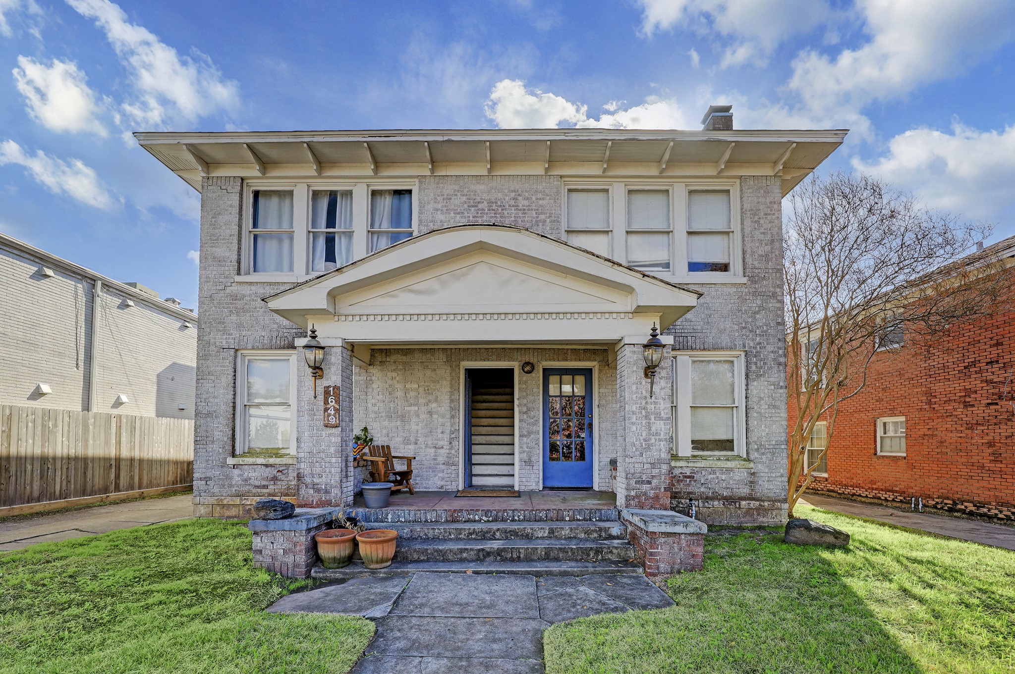 a front view of a house with swing and table