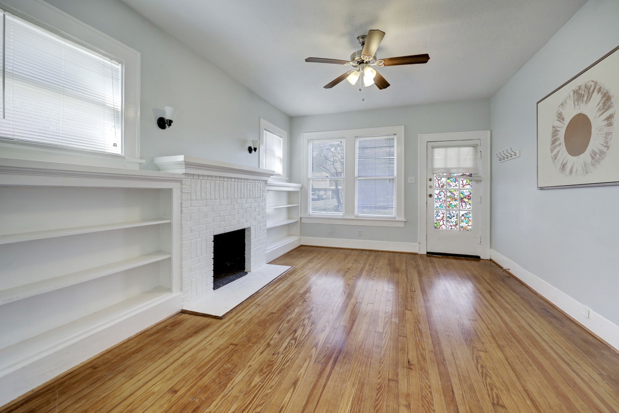 1649 West Main Street, Unit 3 Houston, TX 77006 - Photo 4 of 21 wooden floor fireplace and windows in an empty room