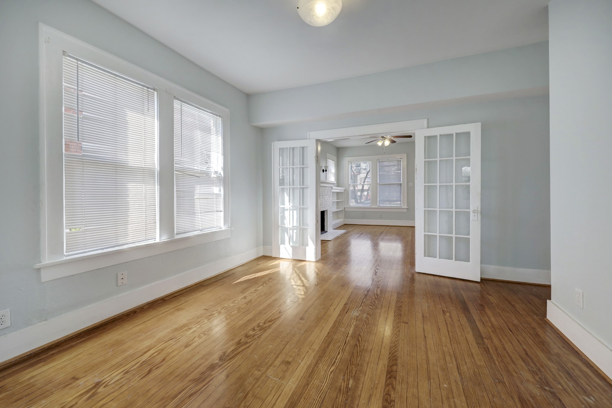 1649 West Main Street, Unit 3 Houston, TX 77006 - Photo 7 of 21 a view of an empty room with wooden floor and a window