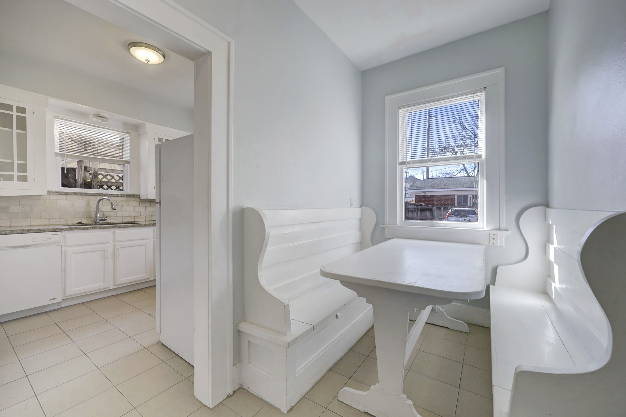 1649 West Main Street, Unit 3 Houston, TX 77006 - Photo 8 of 21 a kitchen with a table chairs and a refrigerator