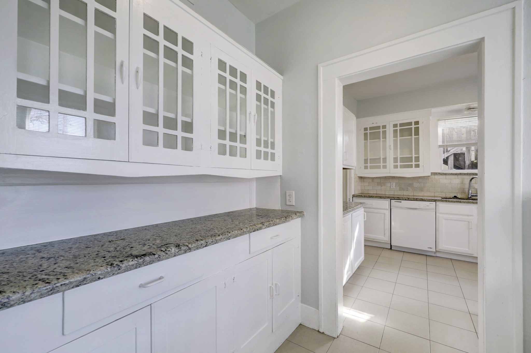 1649 West Main Street, Unit 3 Houston, TX 77006 - Photo 9 of 21 a kitchen with granite countertop white cabinets and white appliances