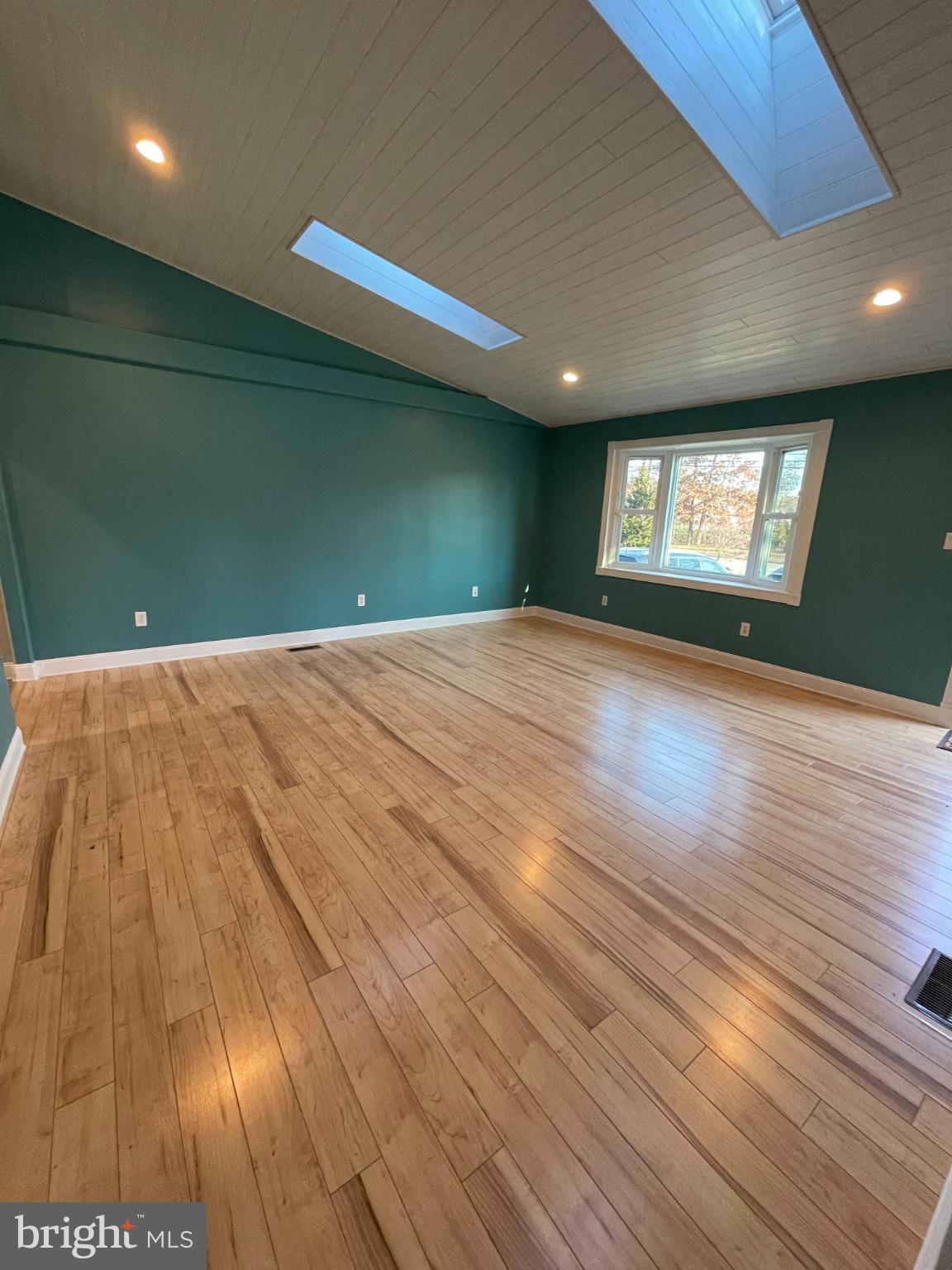 2883 Williamstown Road Franklinville, NJ 08322 - Photo 3 of 8 a view of an empty room with wooden floor and a window