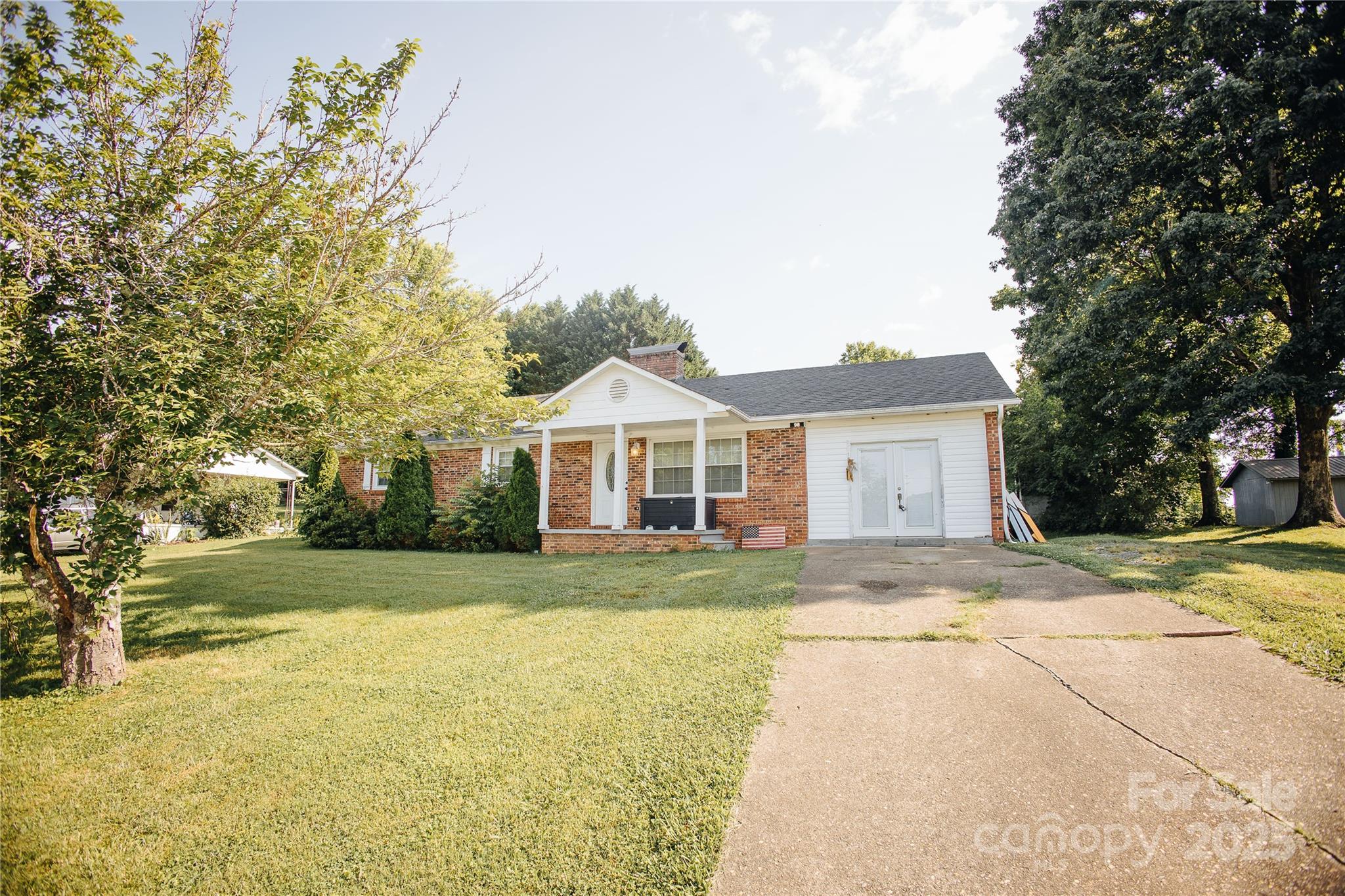 98 Long Street Marion, NC 28752 - Photo 1 of 30 a front view of a house with a yard and garage