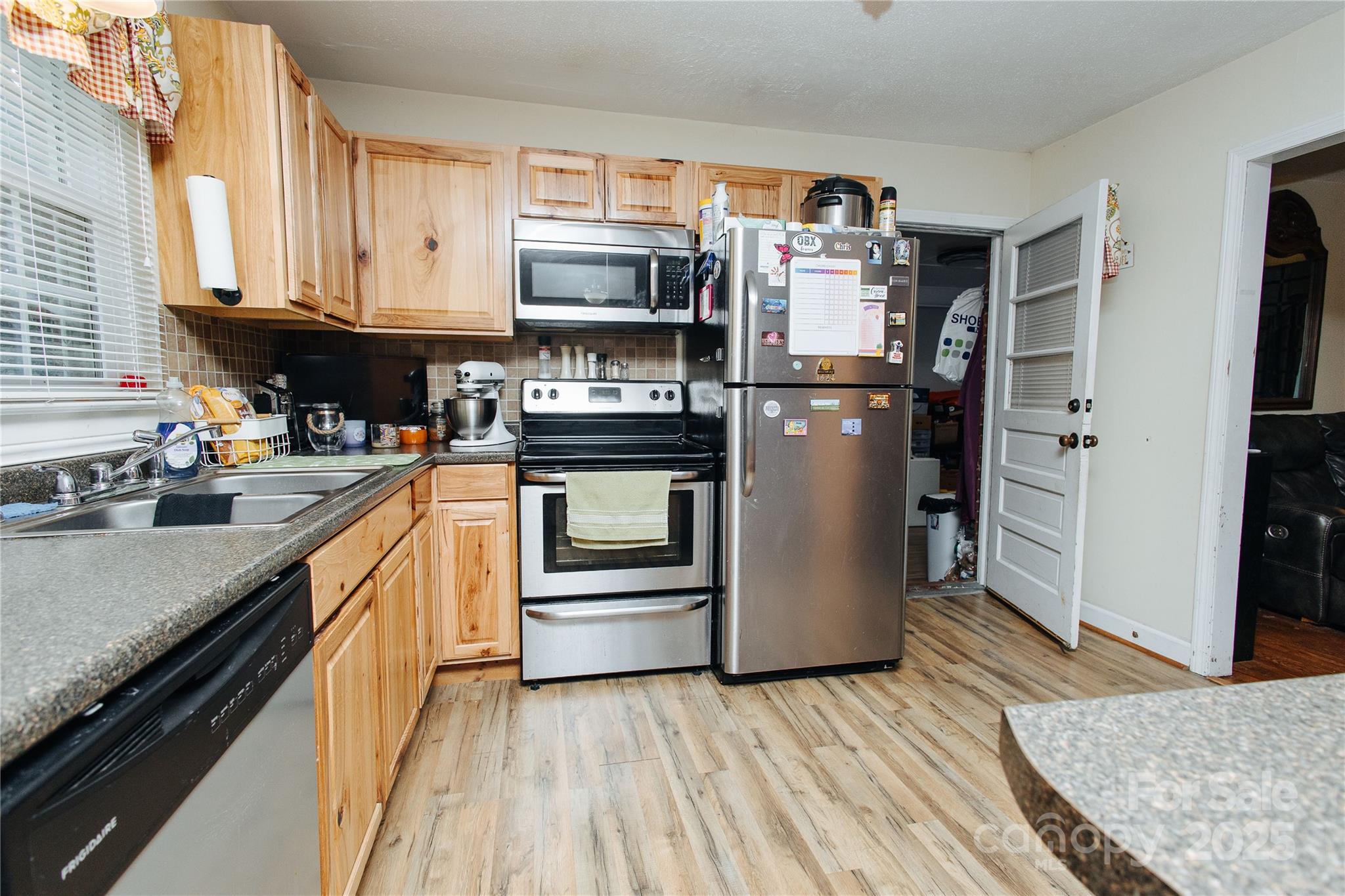 98 Long Street Marion, NC 28752 - Photo 22 of 30 a kitchen with stainless steel appliances granite countertop a refrigerator stove and sink