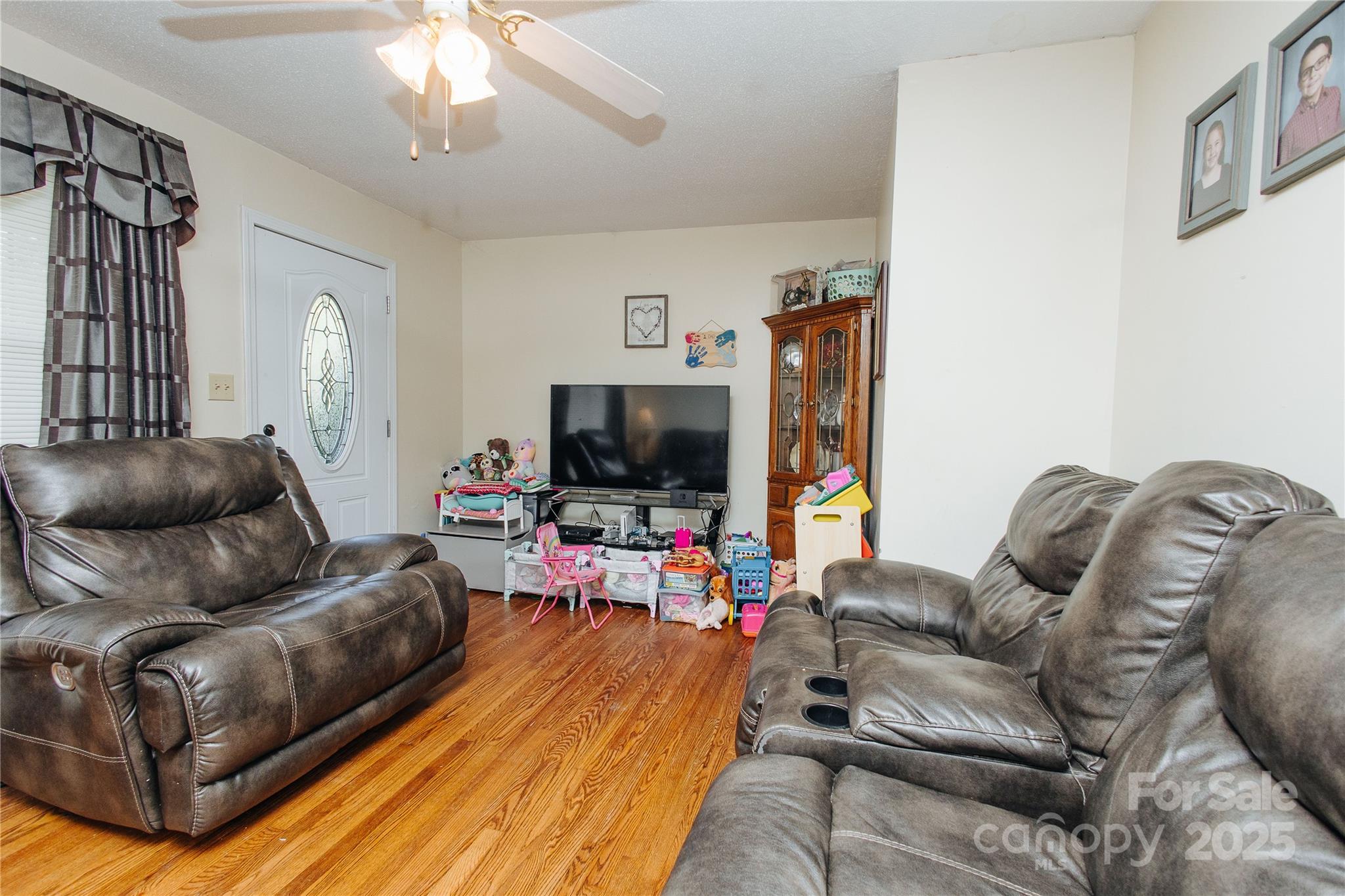 98 Long Street Marion, NC 28752 - Photo 26 of 30 a living room with furniture and a flat screen tv