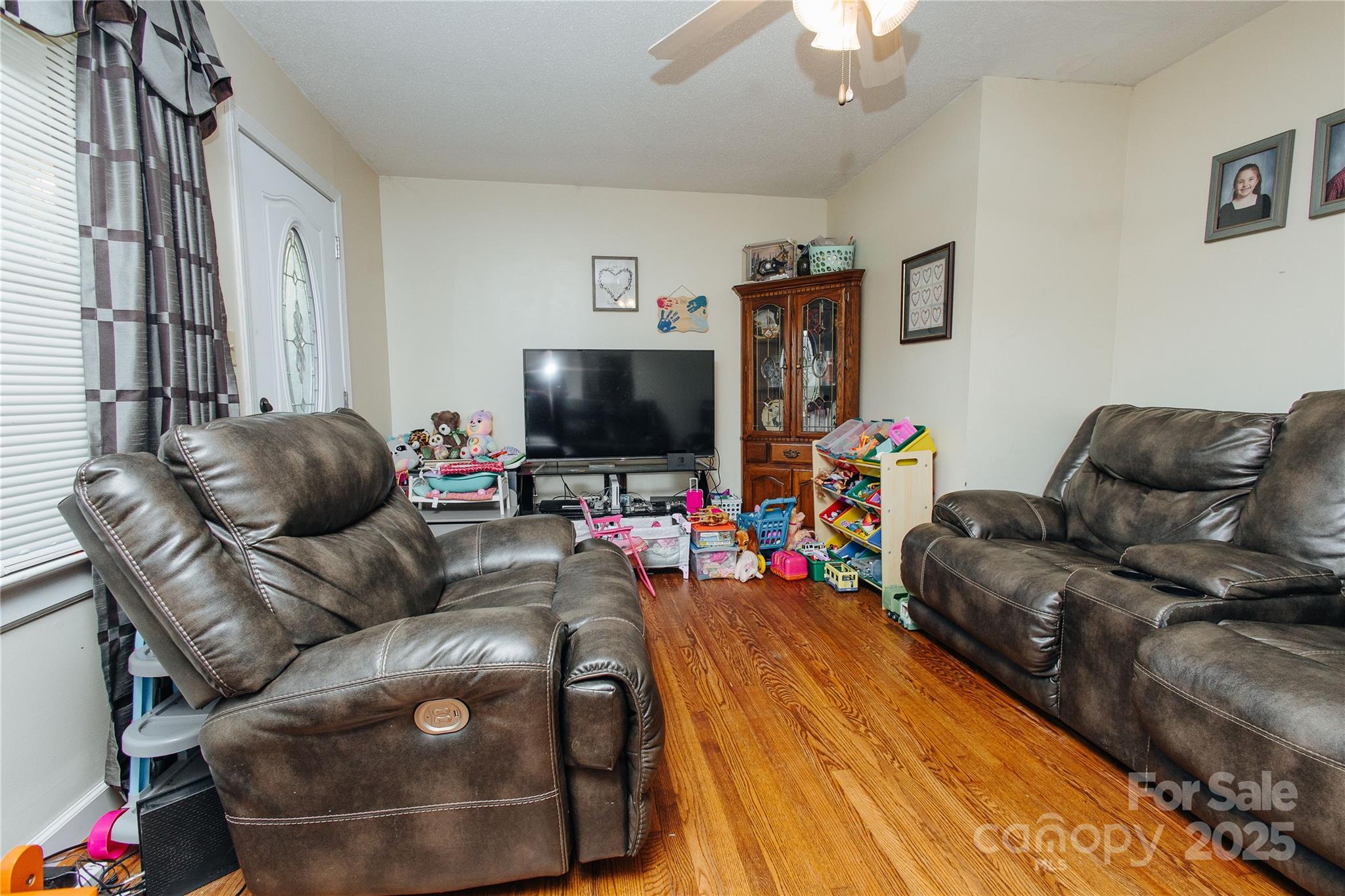 98 Long Street Marion, NC 28752 - Photo 29 of 30 a living room with furniture and a flat screen tv