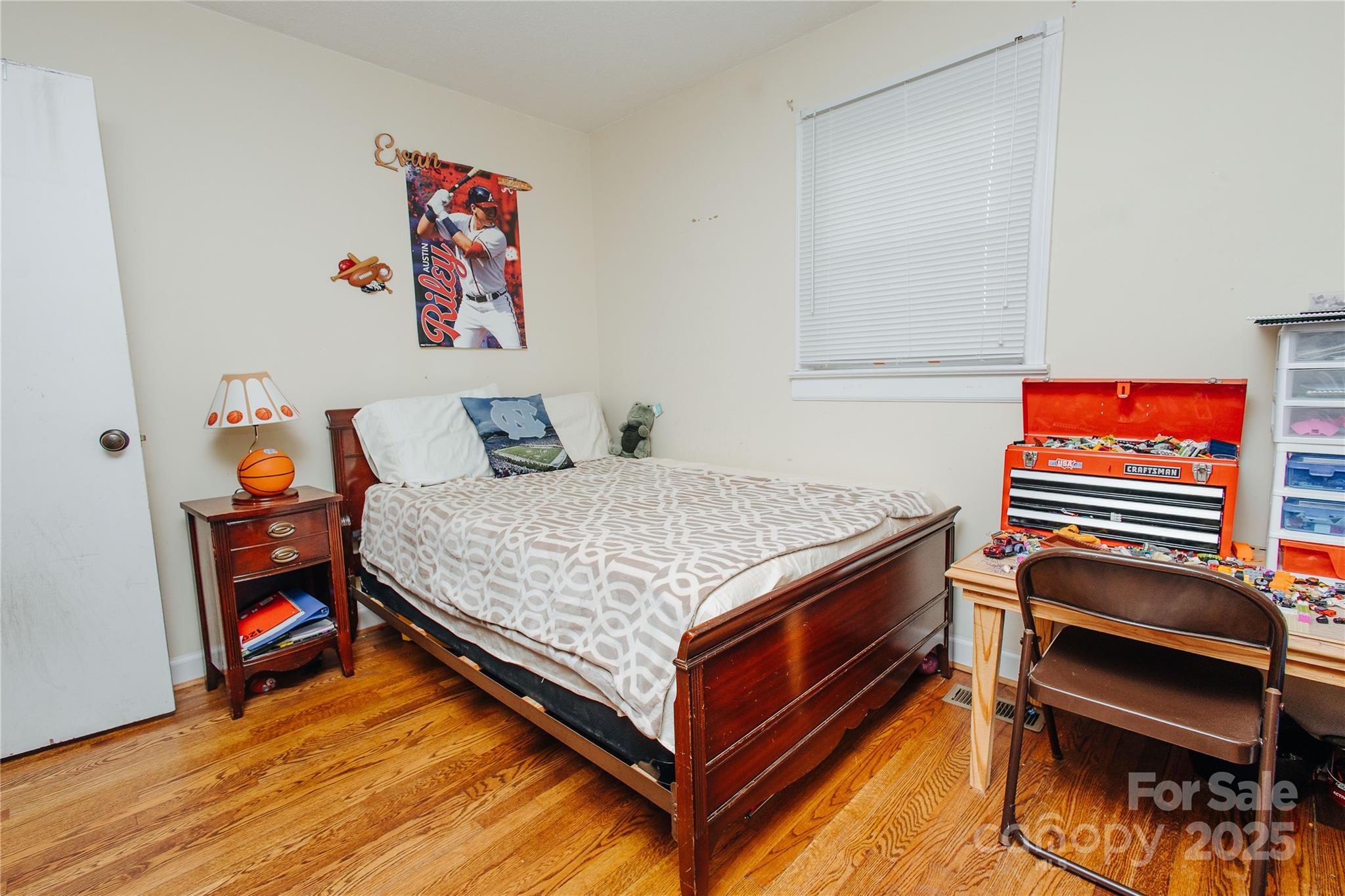 98 Long Street Marion, NC 28752 - Photo 10 of 30 a bedroom with a bed and wooden floor