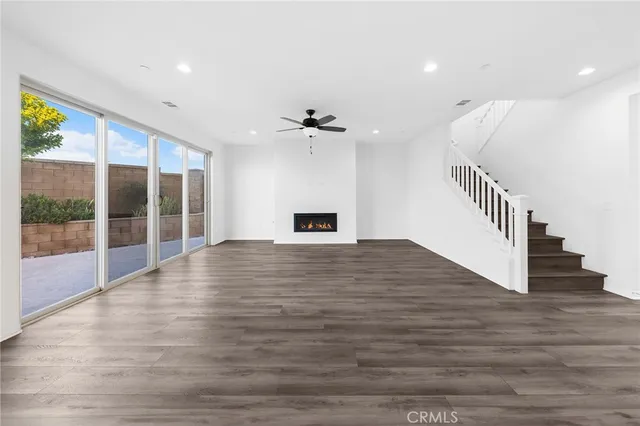 a kitchen with a white wooden cabinets stainless steel appliances and a wooden floor