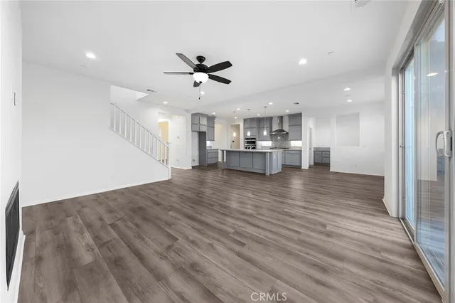 a kitchen with stainless steel appliances kitchen island wooden floors cabinets and wooden floor
