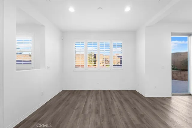 a view of a hallway with wooden floor and entryway