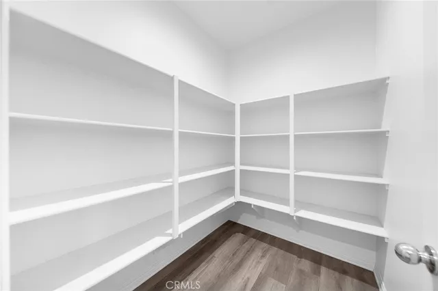 a view of a kitchen with wooden floor and a ceiling fan