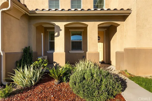 a view of empty room with wooden floor and window