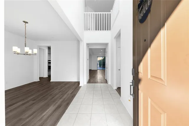a view of an empty room with a ceiling fan and wooden floor