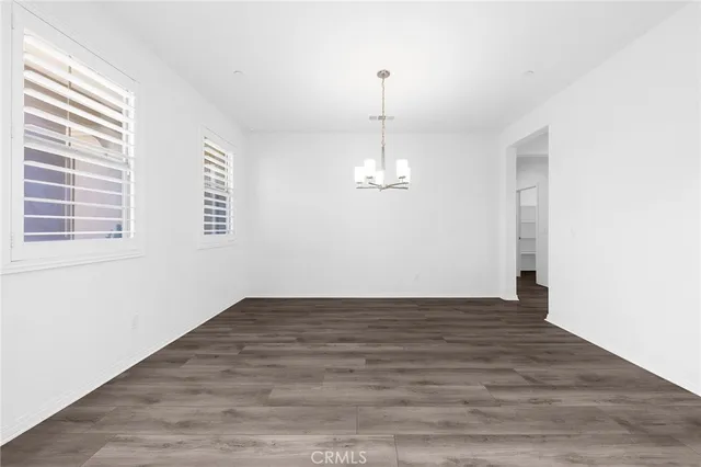 a view of kitchen with kitchen island wooden floor center island and stainless steel appliances