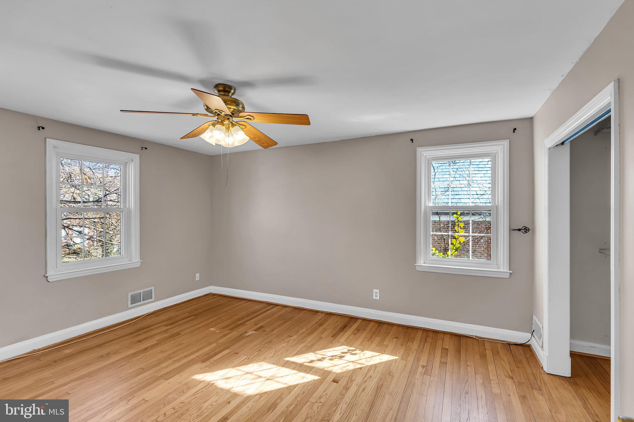 6147 Regent Park Road Catonsville, MD 21228 - Photo 13 of 22 a view of an empty room with wooden floor and a window