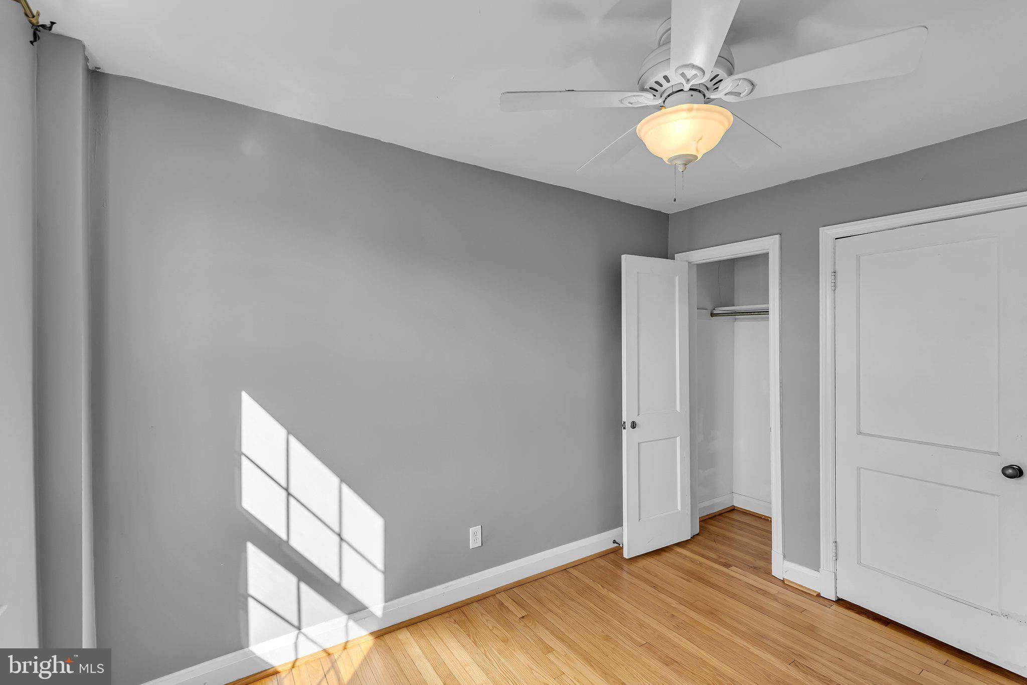 6147 Regent Park Road Catonsville, MD 21228 - Photo 14 of 22 wooden floor in an empty room with a window