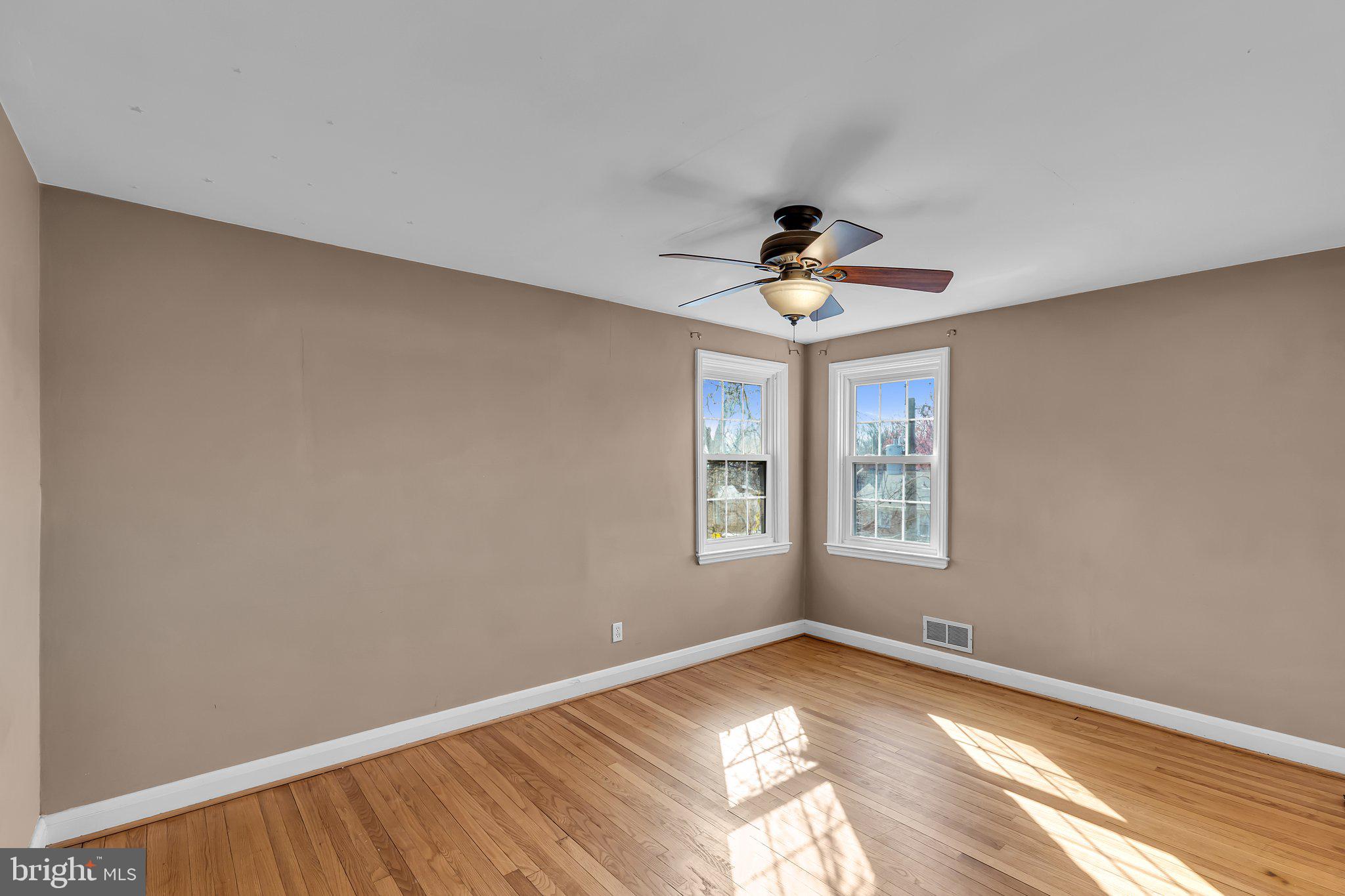 6147 Regent Park Road Catonsville, MD 21228 - Photo 16 of 22 a view of empty room with wooden floor and fan