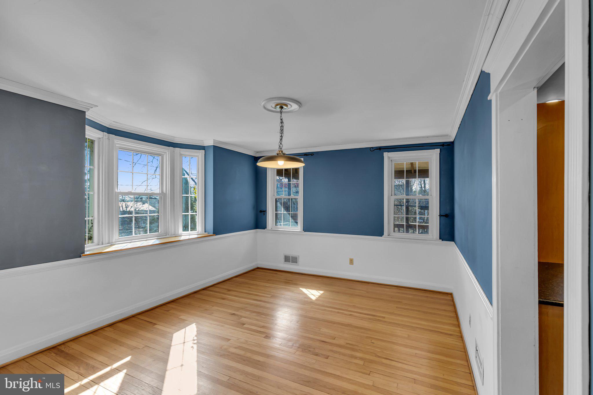 6147 Regent Park Road Catonsville, MD 21228 - Photo 6 of 22 a view of an empty room with window and wooden floor