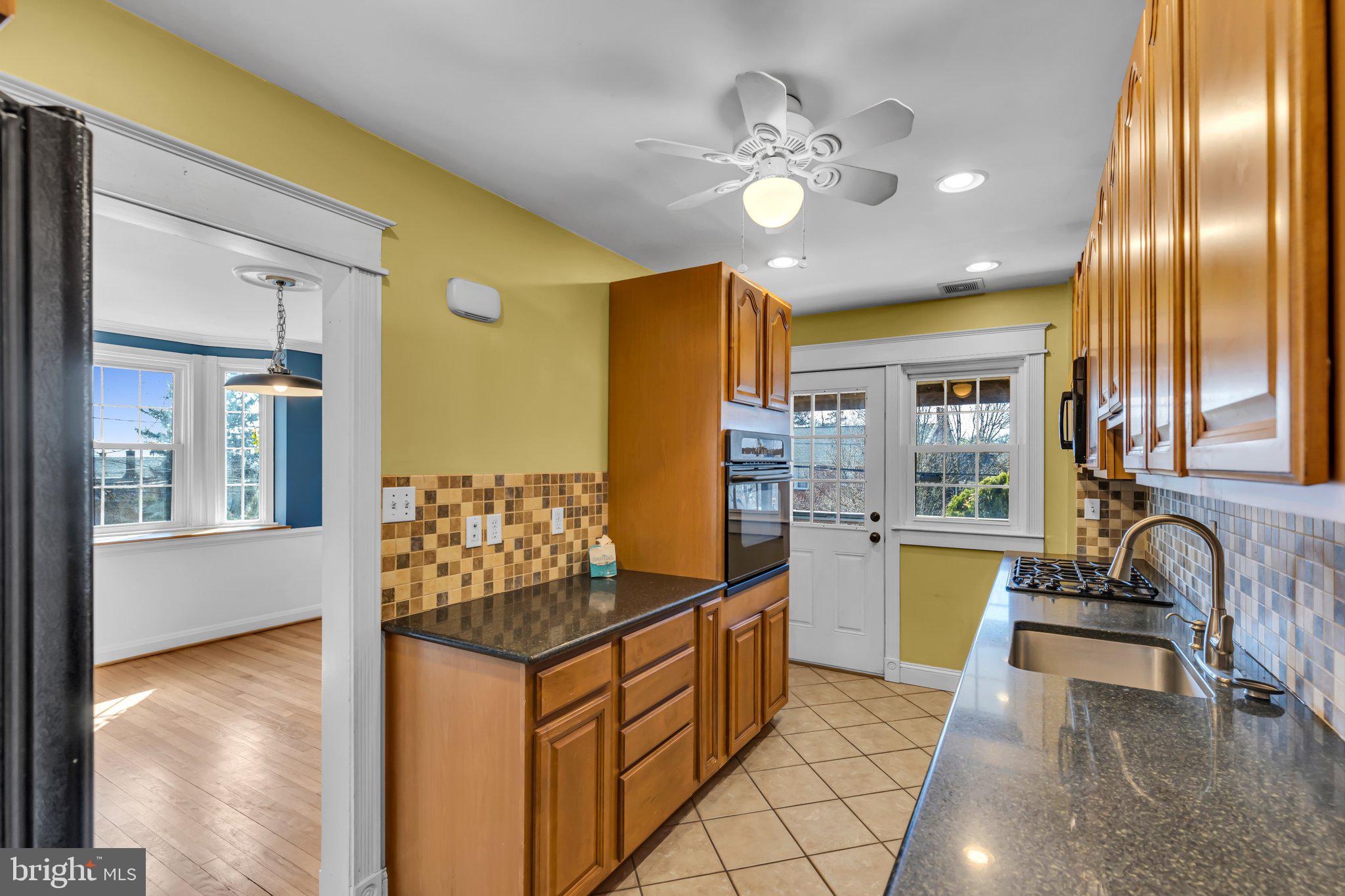 6147 Regent Park Road Catonsville, MD 21228 - Photo 8 of 22 a kitchen with stainless steel appliances granite countertop a sink and cabinets