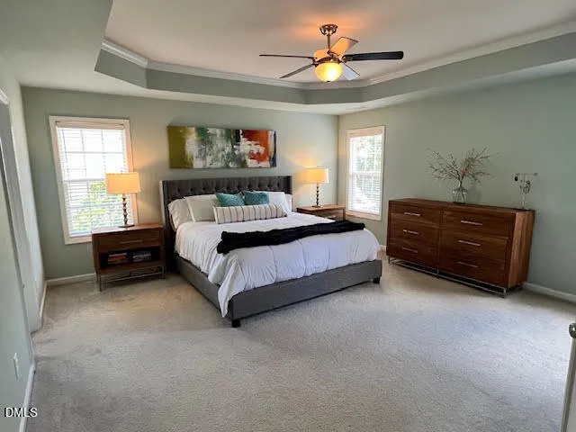 a bedroom with a bed dresser and a window