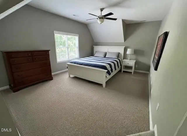 a bedroom with a bed and a mirror