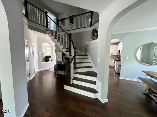 a view of entryway and hall with wooden floor