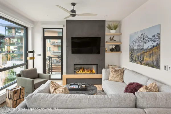 a living room with furniture a fireplace and a flat screen tv