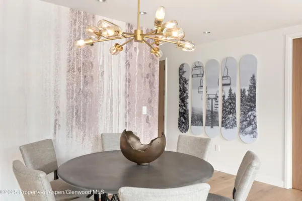 a dining room with furniture and chandelier
