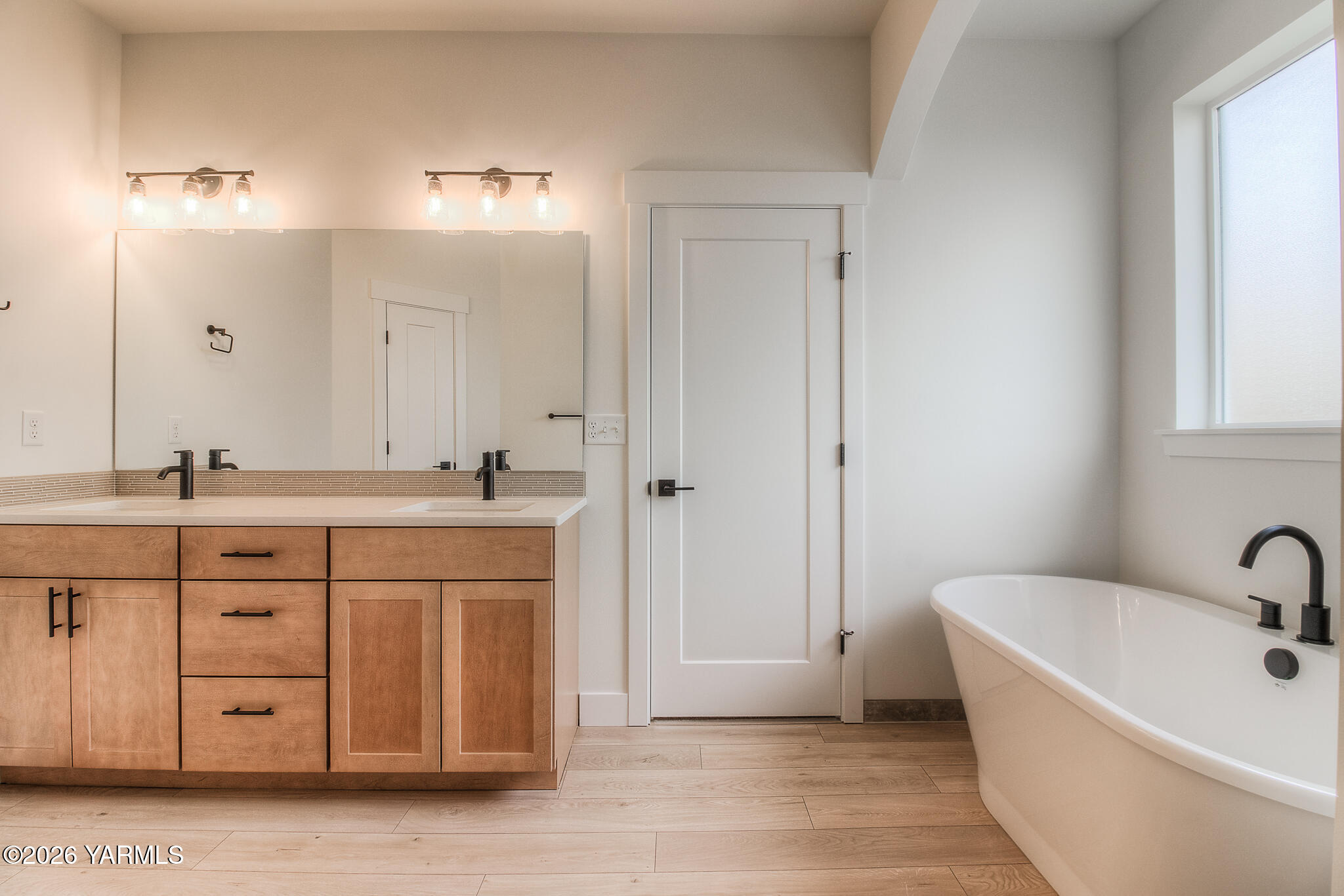 404 South 90th Avenue Yakima, WA 98908 - Photo 19 of 20 a bathroom with a tub sink double vanity and a mirror