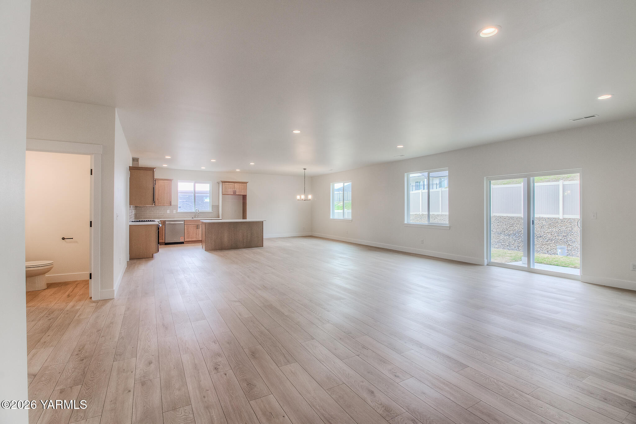 404 South 90th Avenue Yakima, WA 98908 - Photo 7 of 20 a view of empty room with wooden floor and windows