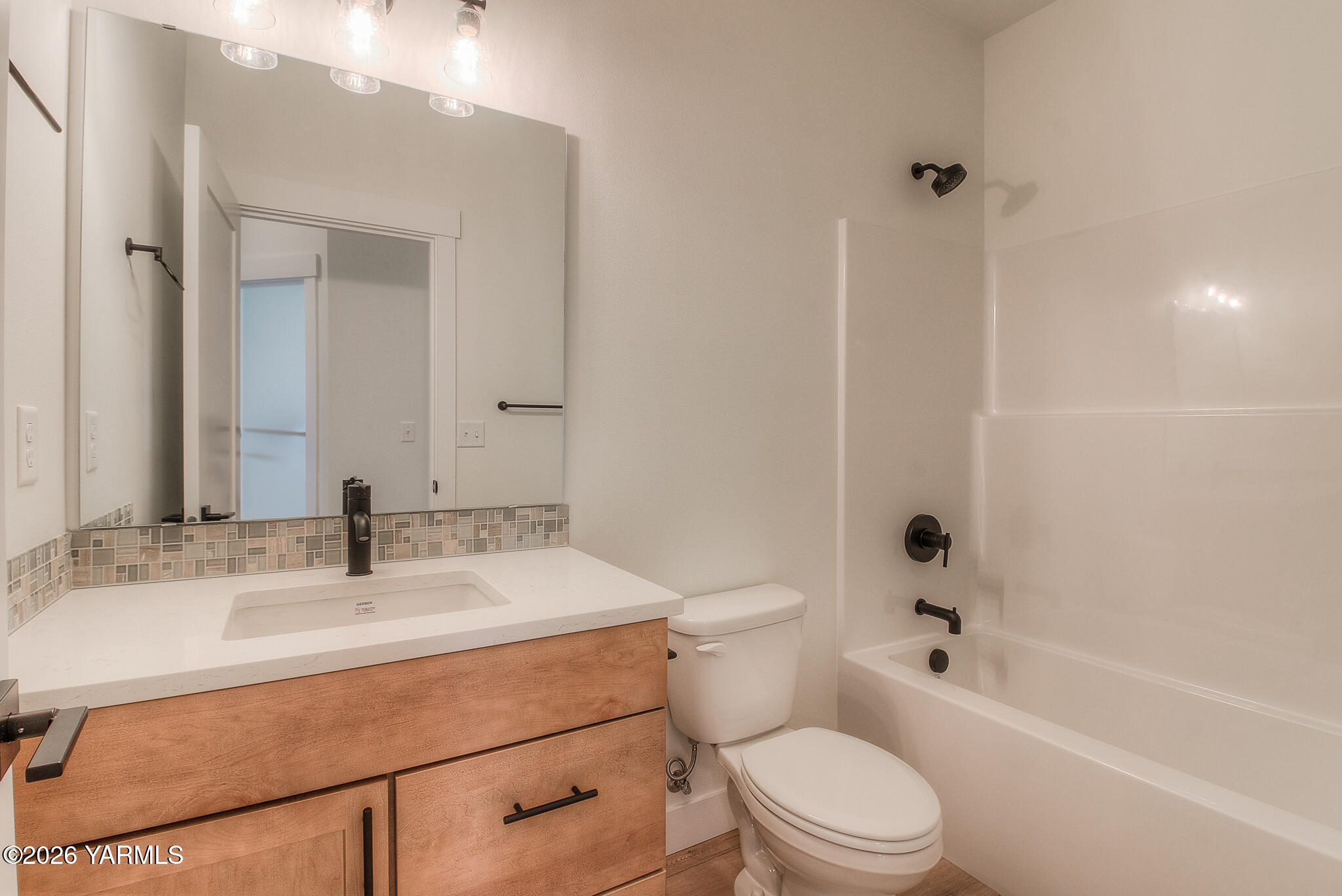 404 South 90th Avenue Yakima, WA 98908 - Photo 8 of 20 a bathroom with a sink toilet vanity and shower