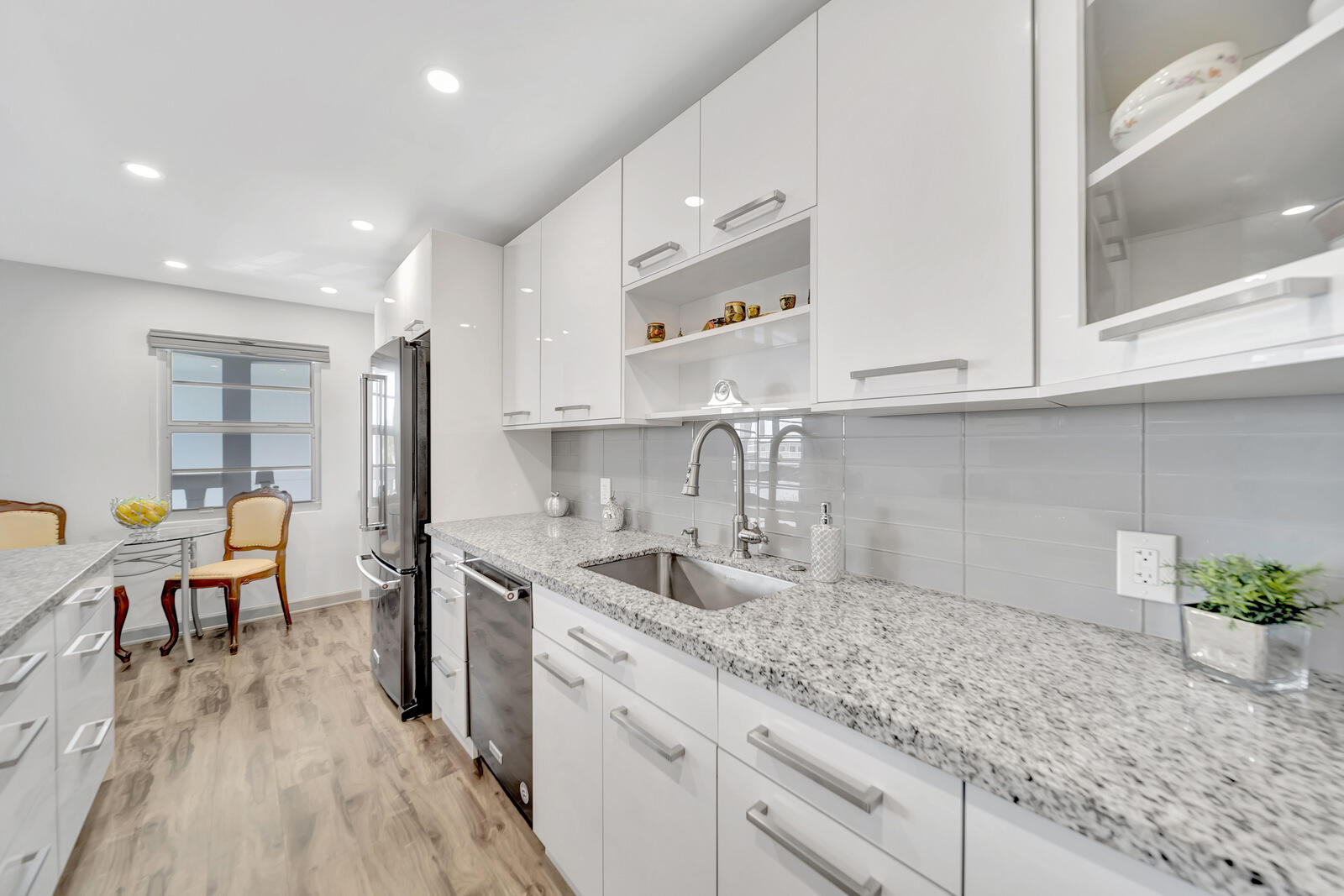 4063 Exeter Boca Raton, FL 33434 - Photo 8 of 55 a kitchen with granite countertop a sink a stove refrigerator and cabinets