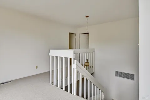 a view of staircase with white floor
