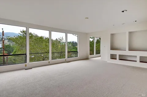 a view of an empty room with a large window