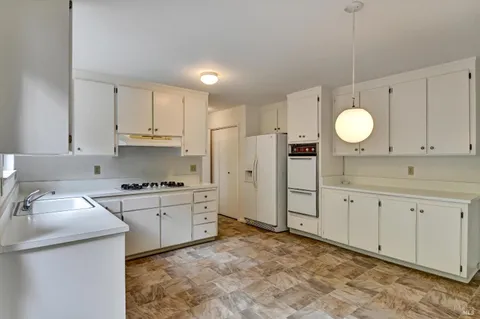 a kitchen with cabinets and appliances