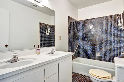 a bathroom with a sink a toilet and bathtub