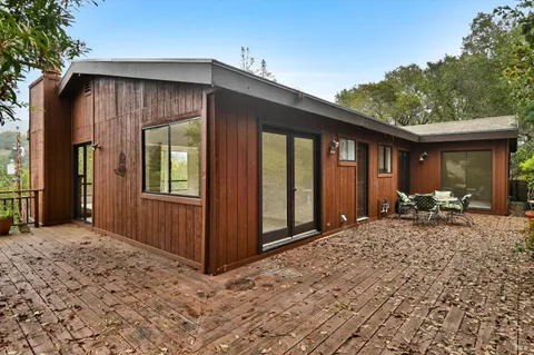 a view of a house with backyard and sitting area