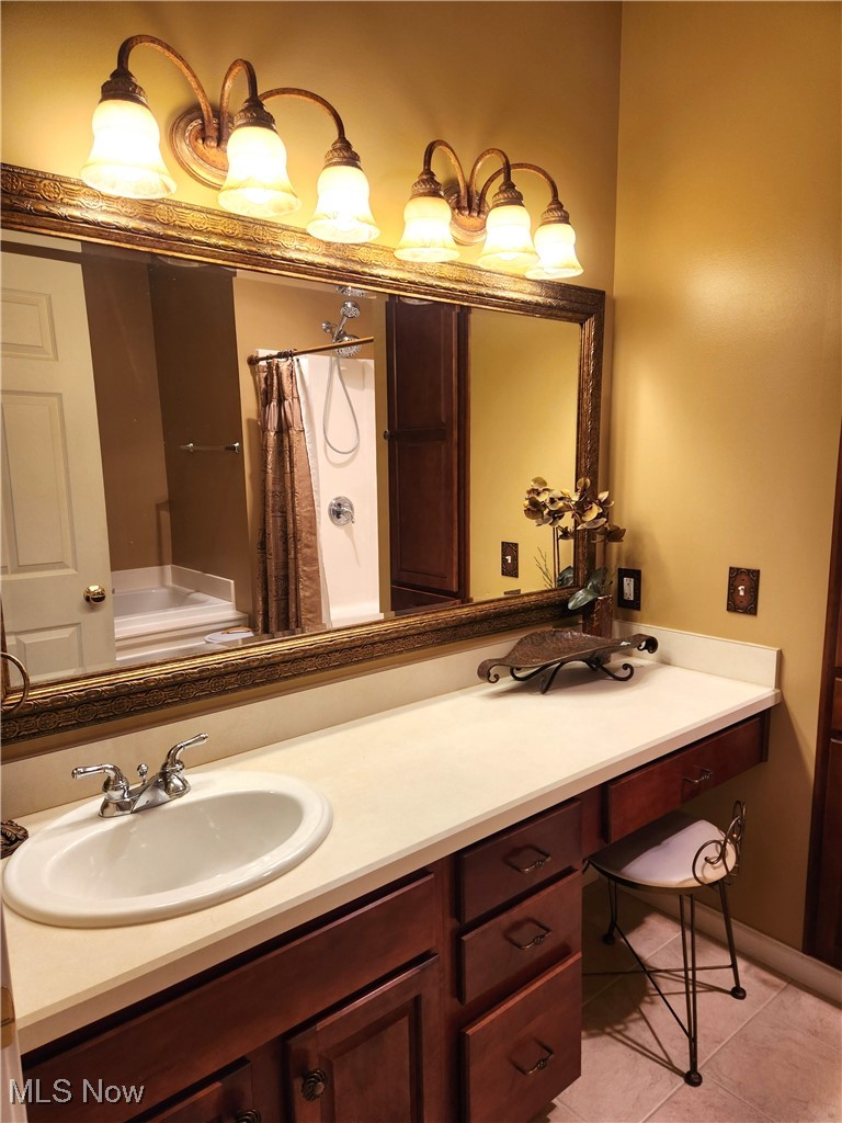 5645 Clingan Road, Unit 18A Struthers, OH 44471 - Photo 24 of 38 Bathroom featuring vanity, curtained shower, and tile patterned floors