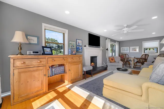 a living room with furniture a fireplace and a flat screen tv