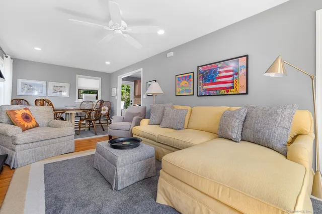 a living room with furniture and kitchen view