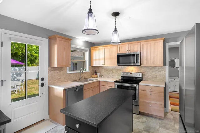 a kitchen with a stove a sink and a microwave