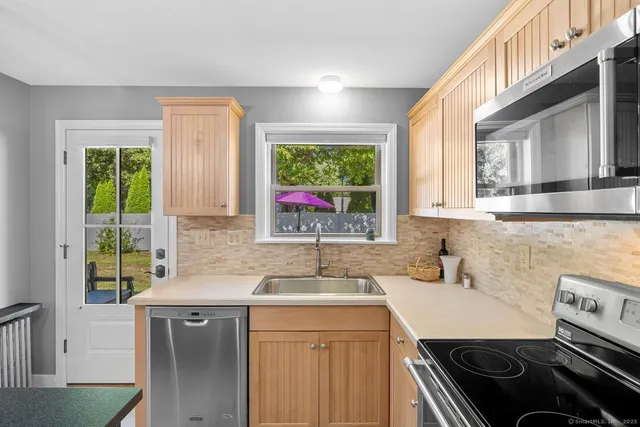 a kitchen with a sink stove top oven and cabinets
