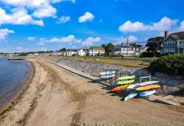 a view of a lake with a swimming pool and sitting area